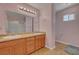 Bathroom featuring a double sink vanity, large mirror, and tile floors at 2435 Paddock Ln, Las Vegas, NV 89156