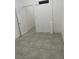 Empty bedroom features white walls and light tile flooring at 2435 Paddock Ln, Las Vegas, NV 89156