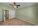 A bedroom with tile floors, a ceiling fan, and neutral wall color at 2435 Paddock Ln, Las Vegas, NV 89156