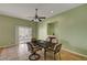 Bright dining area featuring a modern ceiling fan, backyard access, and a cozy fireplace at 2435 Paddock Ln, Las Vegas, NV 89156