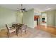 Open dining area with modern light fixture, tile flooring, and flow into other rooms at 2435 Paddock Ln, Las Vegas, NV 89156