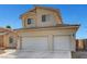 Two story home with a three-car garage and light tan exterior at 2435 Paddock Ln, Las Vegas, NV 89156