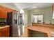 View of a kitchen with stainless steel appliances and earth tone cabinets and counter tops at 2435 Paddock Ln, Las Vegas, NV 89156