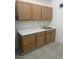 Kitchenette with upper and lower cabinets, sink, and light countertop at 2435 Paddock Ln, Las Vegas, NV 89156
