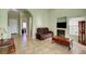 Open-concept living room featuring tile floors, a fireplace, and a brown leather sofa at 2435 Paddock Ln, Las Vegas, NV 89156