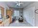 This bedroom features a ceiling fan, work desk, and an easy chair at 2561 Cosmic Dust St, Henderson, NV 89044