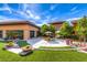 Beautiful courtyard featuring lush landscaping, seating, and a tranquil ambiance at 2561 Cosmic Dust St, Henderson, NV 89044