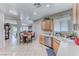 Spacious kitchen with stainless dishwasher and sink features wood cabinets, tile floor at 2561 Cosmic Dust St, Henderson, NV 89044