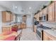 Bright kitchen offers stainless appliances, wooden cabinets, and convenient dining space at 2561 Cosmic Dust St, Henderson, NV 89044