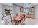 Cozy eat-in kitchen features tile floors, ample cabinetry, and a view into the living area at 2561 Cosmic Dust St, Henderson, NV 89044