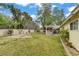 Lush backyard offering a serene outdoor space with mature trees and a covered patio area at 2706 Colanthe Ave, Las Vegas, NV 89102