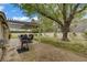 Expansive backyard featuring a large shade tree, covered patio and lush lawn at 2706 Colanthe Ave, Las Vegas, NV 89102