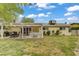 Well-maintained backyard with a covered patio, fenced perimeter, and mature trees at 2706 Colanthe Ave, Las Vegas, NV 89102