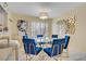 Bright dining area with a glass table, blue velvet chairs, and stylish decor creating a modern atmosphere at 2706 Colanthe Ave, Las Vegas, NV 89102