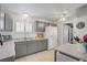 Inviting kitchen featuring grey cabinets, tile flooring, and bright lighting at 2706 Colanthe Ave, Las Vegas, NV 89102