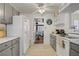 Well-lit kitchen with grey cabinets, tile floors, and modern appliances at 2706 Colanthe Ave, Las Vegas, NV 89102