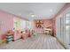 Inviting living room with plush pink sofa, piano, and expansive windows providing natural light at 2706 Colanthe Ave, Las Vegas, NV 89102