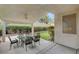 Covered back patio featuring dark table and chairs, and green backyard at 2727 Warm Rays Ave, Henderson, NV 89052