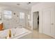 Bathroom showcases a bathtub with gold fixtures, natural light, and a calming ambiance at 2727 Warm Rays Ave, Henderson, NV 89052