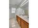 Bright bathroom featuring double sinks with classic cabinetry and decor accents, and plenty of natural light at 2727 Warm Rays Ave, Henderson, NV 89052