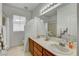 Bright bathroom featuring double sinks with classic cabinetry and decor accents, and plenty of natural light at 2727 Warm Rays Ave, Henderson, NV 89052