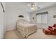 Bedroom with neutral decor, plush carpet, window, fan and red chair at 2727 Warm Rays Ave, Henderson, NV 89052