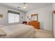 Bedroom features neutral tones, dresser with mirror and soft natural light at 2727 Warm Rays Ave, Henderson, NV 89052