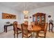 Formal dining room boasts an oval table with seating for six, enhanced by a decorative chandelier at 2727 Warm Rays Ave, Henderson, NV 89052