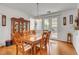 The dining room features a wood table and chairs, wood floors, and access to the backyard at 2727 Warm Rays Ave, Henderson, NV 89052
