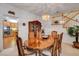 The dining room has a wood table set with seating, a view of the kitchen, and access to the staircase at 2727 Warm Rays Ave, Henderson, NV 89052