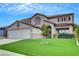 Beautiful two-story home featuring an expansive green lawn, perfect for outdoor activities and relaxation at 2727 Warm Rays Ave, Henderson, NV 89052