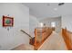 Upstairs hallway with natural wood railing and neutral walls providing warm feeling at 2727 Warm Rays Ave, Henderson, NV 89052