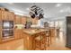 Spacious kitchen with a central island, stainless steel appliances, and rich wood cabinetry at 2727 Warm Rays Ave, Henderson, NV 89052