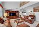 Spacious living room with high ceilings, a large entertainment center, and comfortable leather seating at 2727 Warm Rays Ave, Henderson, NV 89052