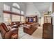 Inviting living room featuring high ceilings, leather furniture, and plenty of natural light at 2727 Warm Rays Ave, Henderson, NV 89052