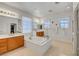 Bright main bathroom featuring dual vanities, a soaking tub, and lots of space at 2727 Warm Rays Ave, Henderson, NV 89052