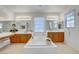 Light-filled bathroom boasts a large soaking tub and dual vanities at 2727 Warm Rays Ave, Henderson, NV 89052