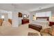 Comfortable main bedroom has a wooden bed with a leather bench at the foot at 2727 Warm Rays Ave, Henderson, NV 89052
