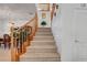 Carpeted staircase with natural wood railing leading to the upper level of the home at 2727 Warm Rays Ave, Henderson, NV 89052