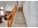Carpeted staircase with natural wood railing leading to the upper level of the home at 2727 Warm Rays Ave, Henderson, NV 89052