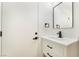 Modern bathroom with door leading in, single sink vanity, and neutral color at 2958 Al De La St, Las Vegas, NV 89146