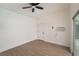 Bright bedroom featuring hardwood floors, a ceiling fan, and air conditioning unit for comfort at 2958 Al De La St, Las Vegas, NV 89146