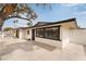 Side view of the single-story home featuring desert landscaping, a driveway, and security bars on the windows at 2958 Al De La St, Las Vegas, NV 89146