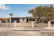 Charming single-story home with a wrought iron fence, gravel yard, and mature landscaping at 2958 Al De La St, Las Vegas, NV 89146