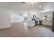 Open-concept living area with updated kitchen featuring white cabinets and stainless appliances at 2958 Al De La St, Las Vegas, NV 89146