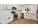 Updated kitchen features stainless steel appliances, white cabinets, and light countertops at 2958 Al De La St, Las Vegas, NV 89146