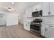 Updated kitchen with white cabinets, stainless steel appliances, and light countertops at 2958 Al De La St, Las Vegas, NV 89146