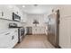 Updated kitchen features stainless steel appliances, white cabinets, and light countertops at 2958 Al De La St, Las Vegas, NV 89146