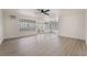 Bright living room with modern flooring, large windows, and a ceiling fan at 2958 Al De La St, Las Vegas, NV 89146