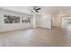 Bright and open living room featuring laminate flooring, multiple windows, and neutral, modern paint at 2958 Al De La St, Las Vegas, NV 89146